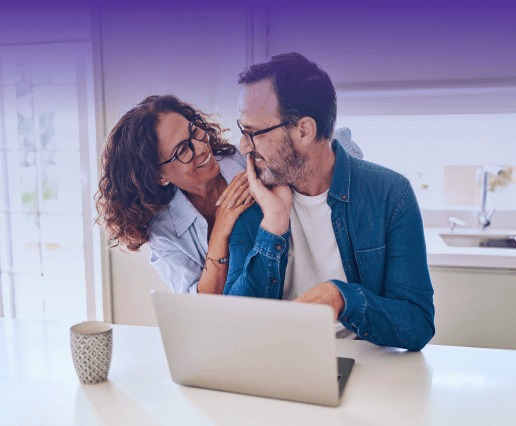 A happy couple looking at a laptop_mobile
